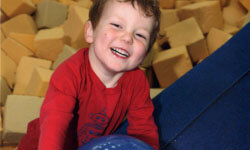 KinderGym - smiling child in foam pit